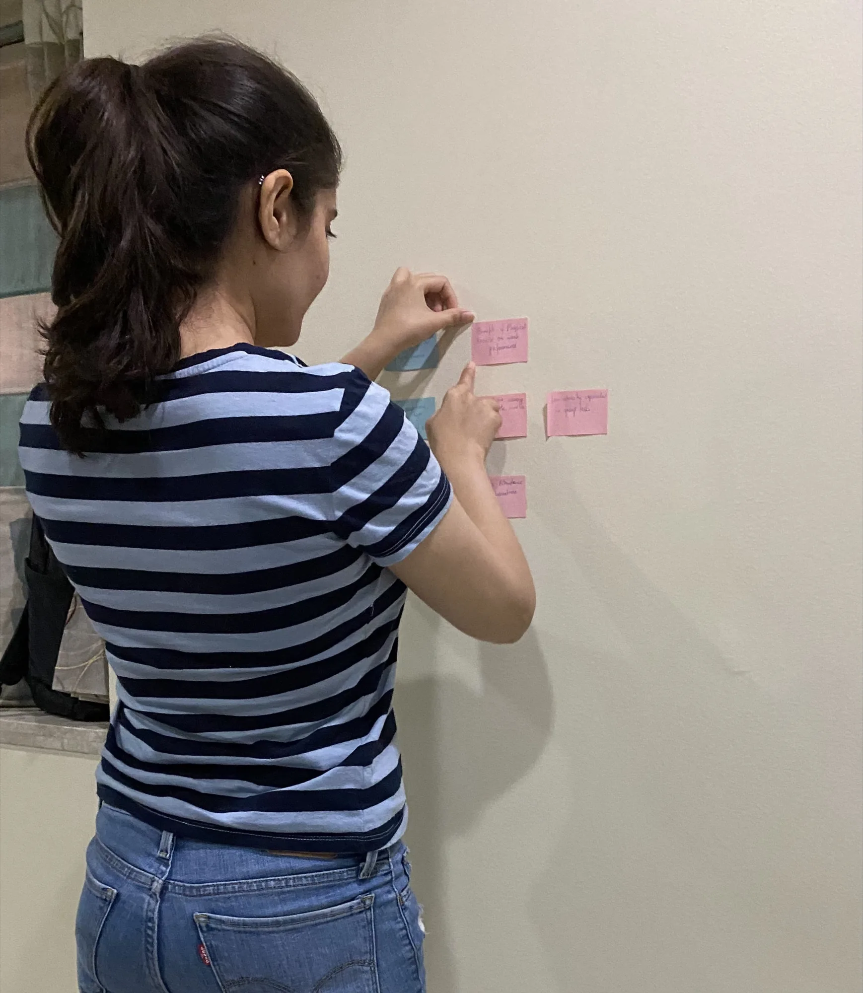 Darshi clustering handwritten notes on a wall